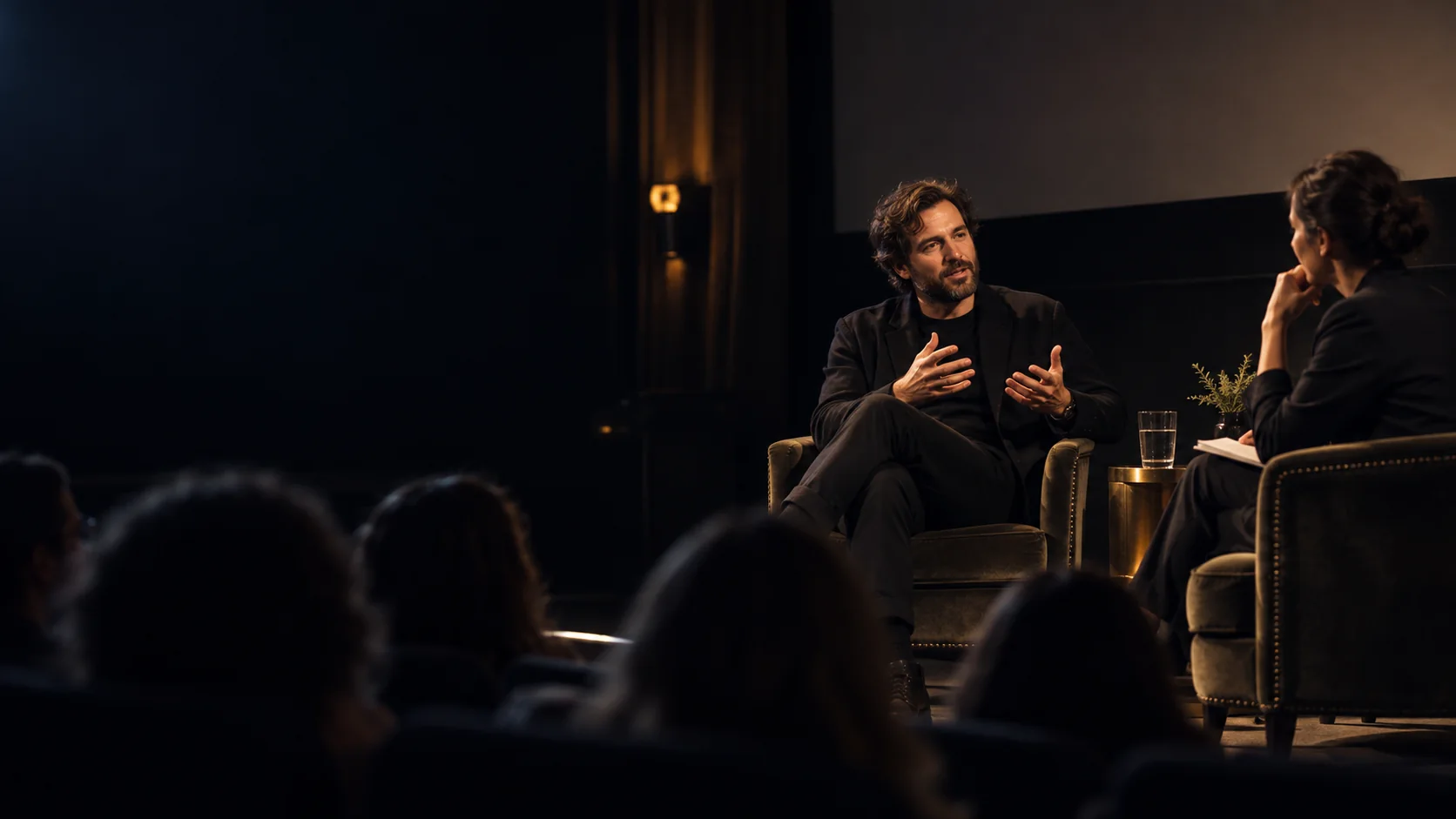A filmmaker and moderator talking with an audience after a documentary screening
